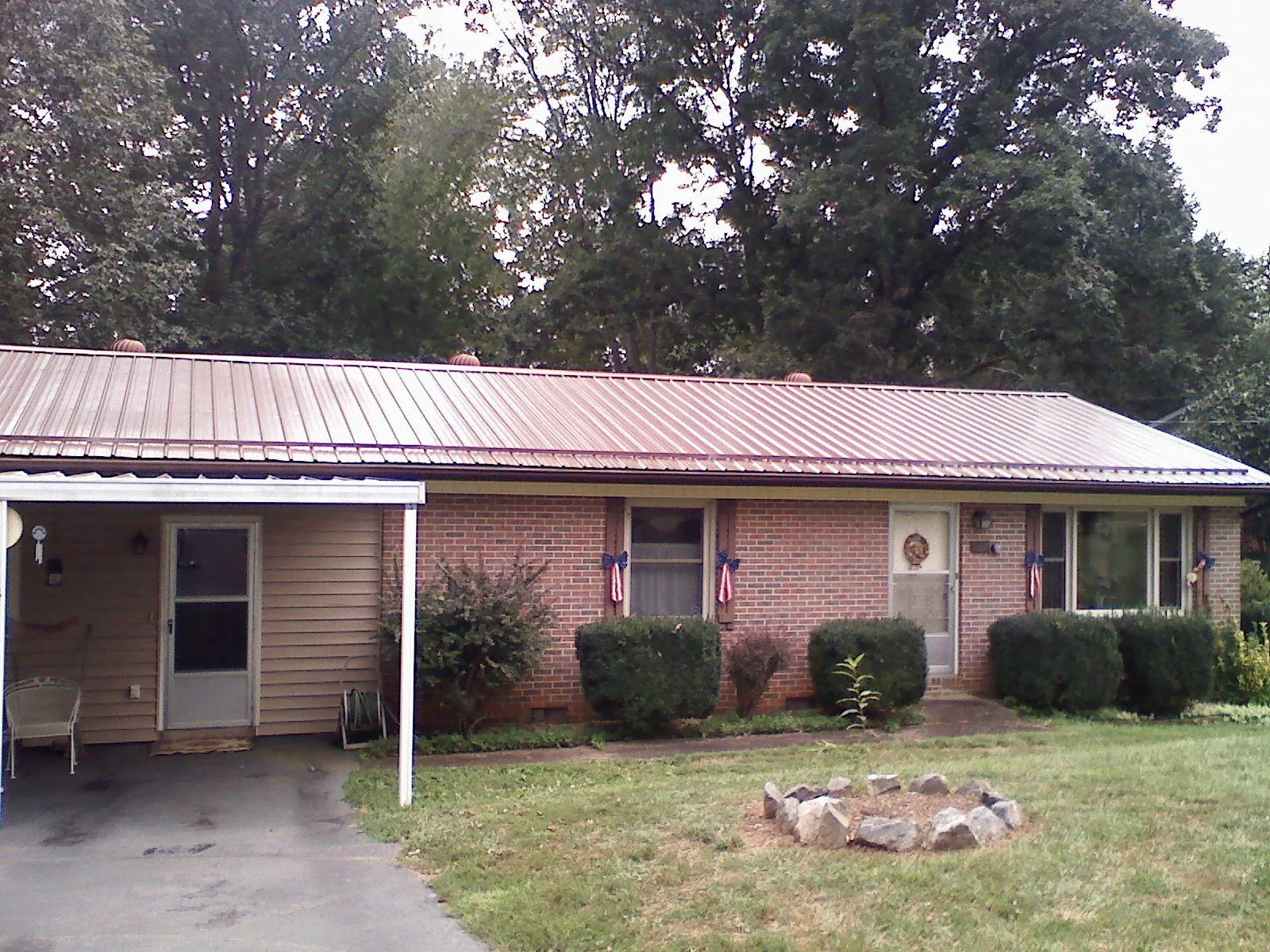 Bronze metal roof and carport on a brick ranch home — Roof Repair work by our crew in Rock Hill